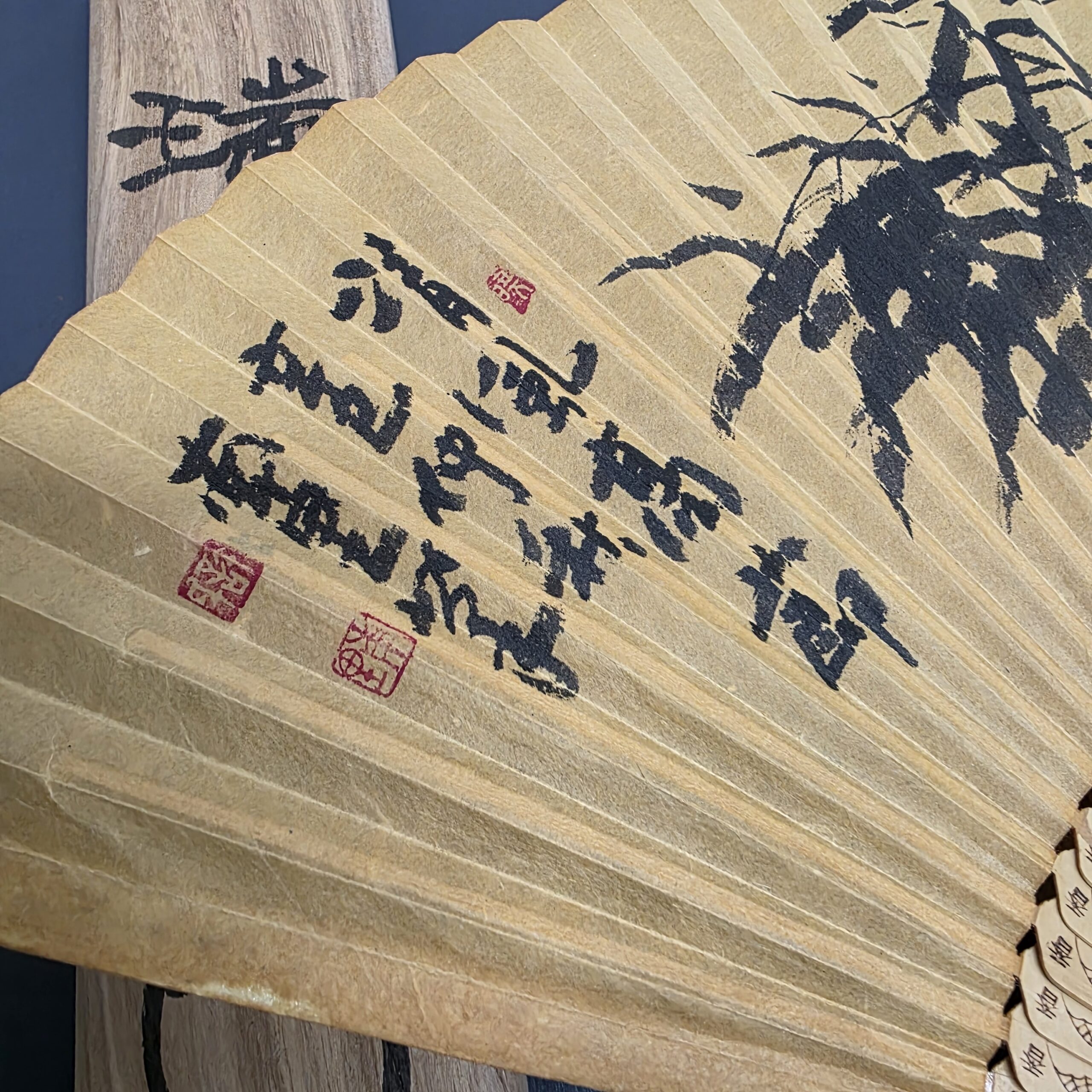 Close-up of handwritten calligraphy and red seals on traditional Korean Hapjukseon fan