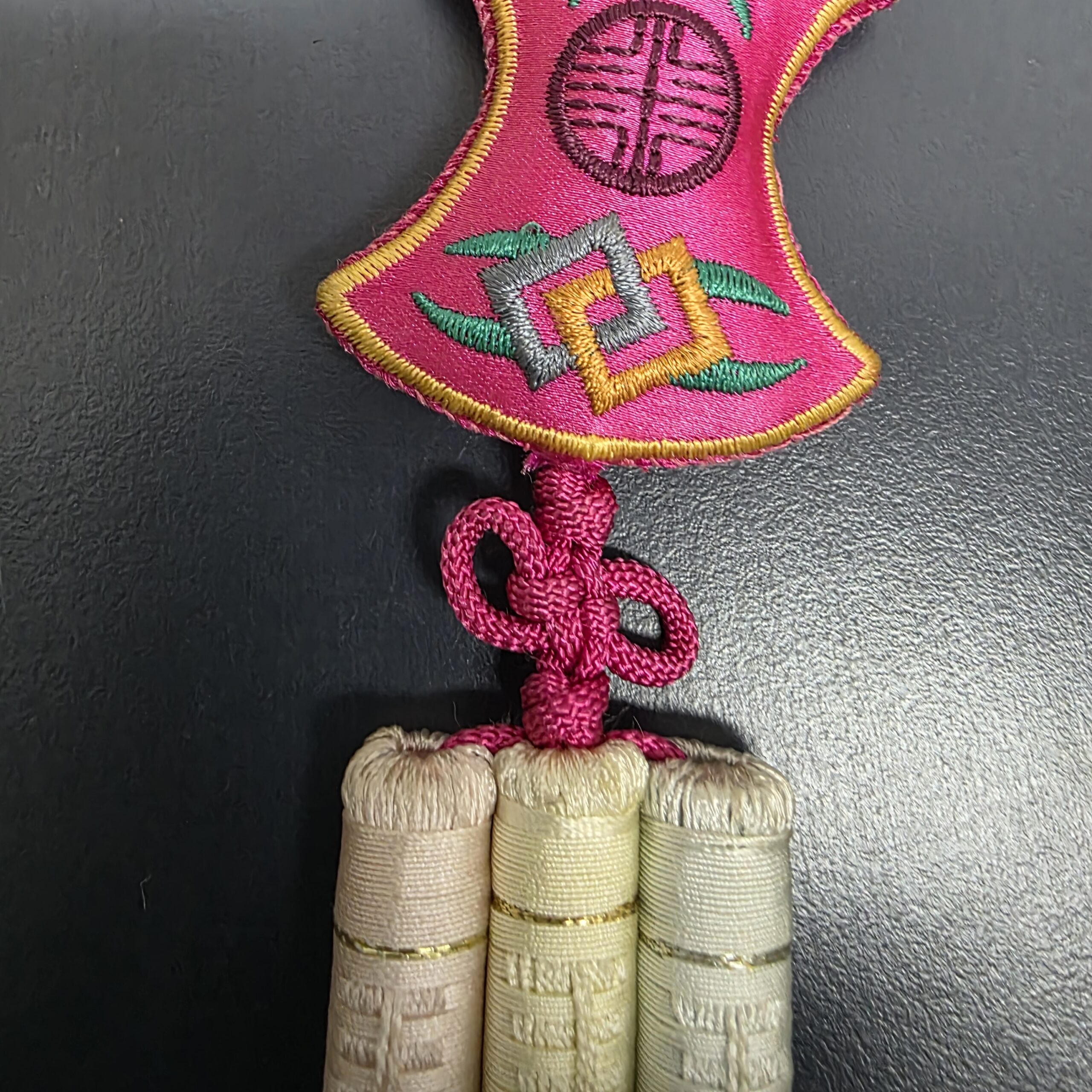 Lower knot and three wrapped tassel heads on traditional Korean norigae