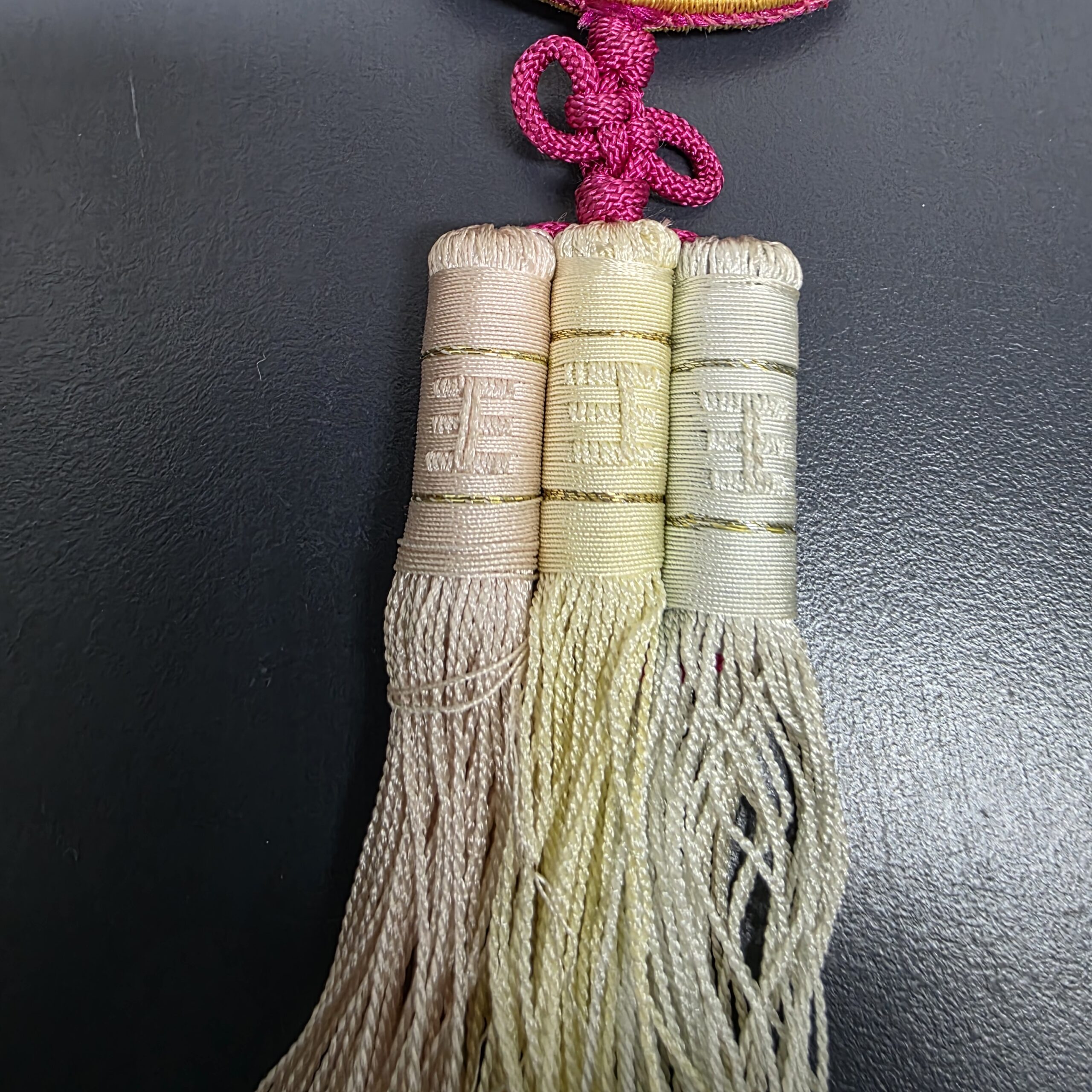 Three multicolor tassels on handcrafted traditional Korean norigae